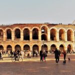 Tourists gather at the ancient Verona Arena in Italy, a Roman amphitheater rich in history.